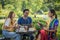 Group of diverse asian university LGBTQ student classmate as teamwork doing group homework together in campus park