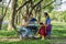 Group of diverse asian university LGBTQ student classmate as teamwork doing group homework together in campus park