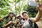 Group of diverse cyclists in the forest taking picture