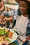 Group of diverse friends serving a balanced dinner al fresco in urban setting