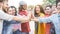 Group of diverse friends stacking hands outdoor - Happy young people having fun joining and celebrating together