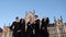 Group of diverse graduation students throwing their mortarboards into the air.