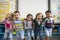 Group of diverse kindergarten students standing together in classroom