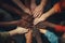 Group of diverse people holding hands together in a circle. Unity concept, Close-up of diverse people joining their hands, top