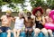 Group of diverse senior adults sitting by the pool enjoying summer together