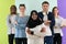 group of diverse teenagers posing in a studio, determined teenagers in diverse clothing.