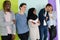 group of diverse teenagers posing in a studio, determined teenagers in diverse clothing.