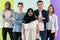 group of diverse teenagers posing in a studio, determined teenagers in diverse clothing.