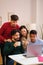 Group of diverse university colleagues studying together with a laptop.