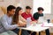 Group of diverse university colleagues studying together at shared flat.