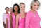 Group of diverse women wearing pink tops and ribbons for breast