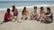 Group of diverse young men and women at the beach