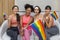 Group of diversity woman in sport wear holding LGBTQ rainbow flag for pride month to promote equality and differences of