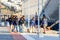 A group of dock workers pulling a mooring line of a cruise ship, docked in Mykonos, Greece