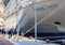 A group of dock workers pulling a mooring line of a cruise ship, docked in Mykonos, Greece