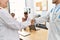 Group of doctor clapping to partners handshake in a medical meeting at the clinic office