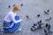 Group doves on city square waiting treats. Share generosity. Girl blonde woman relaxing city square and feeding pigeons