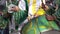 A group of drummers playing rhythmic music during the parade at the carnival. Dressed in colorful traditional costumes.