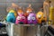 Group of Easter colored eggs with dramatic faces in a pot, with flames behind