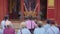 Group of elderly asian women praying in a buddhist temple