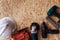 Group of electric hand tools jigsaw, grinder, drill, nail gun and white safety helmet on wooden background