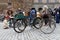 Group of elegant people with bicycles wearing old fashioned twee