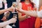 Group of elegant people holding glasses of champagne at luxury w