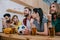 group of emotional friends sitting at bar counter with soccer ball beer and chips during watch of football