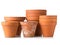 Group of empty, stacked, used terracotta planting pots over whit