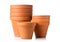 Group of empty, stacked, used terracotta planting pots over whit