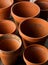 Group of empty, used terracotta planting pots on wooden table