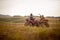 Group of energetic friends driving quads together