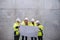 A group of engineers standing against concrete wall on construction site.