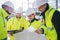 A group of engineers standing on construction site, working.