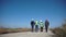 Group of engineers walking against wind farm