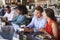 Group Enjoying Business Lunch At Delicatessen Counter