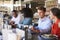 Group Enjoying Business Lunch At Delicatessen Counter