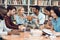 Group of ethnic multicultural students in library. Students are talking and reading.