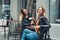 Group of european girls having a coffee together. Two women at cafe talking, laughing, gossiping and enjoying their time.