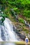 A group of european tourists relaxing in freshwater of waterfall