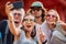 Group of european tourists taking group selfie at buddhist temple in thailand