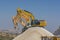 Group of excavators on gravel hill