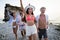 Group of excited young friends having fun together at he beach