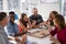 Group of executives interacting while having pizza