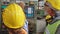 Group of factory workers using machine equipment in factory workshop