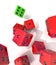Group of falling red dices with one winning green