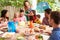 Group Of Families Celebrating Child\'s Birthday At Home