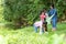 Group family asian children collecting garbage and plastic on the river to dumped into the trash for volunteer charity save enviro