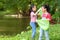 Group family asian children collecting garbage and plastic on the river to dumped into the trash for volunteer charity save enviro