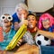 Group of family friends football supporter exult watching match on tv - caucasian mixed ages young adult and mature people have